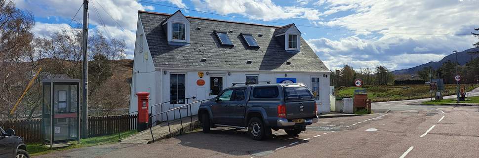 photo of the exterior of the store with a car parked outside the entrance